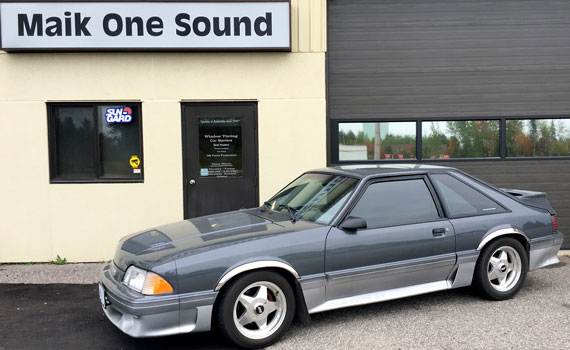 1987 Mustang GT in front of the store